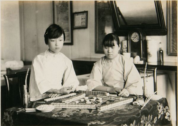 Two Chinese women playing mahjong during the 1920's.